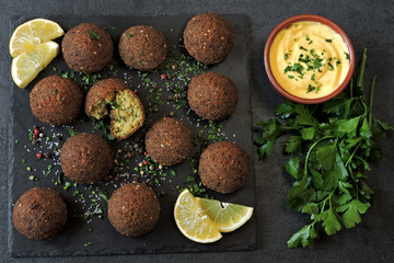 Falafel with sauce, spices and herbs. Middle Eastern cuisine.