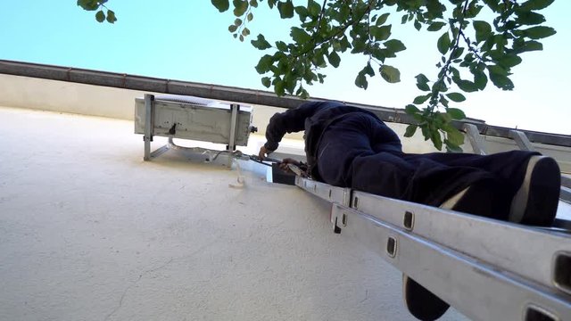 Techican man electrician installing air conditioning in a client house, cinematic steadicam shot