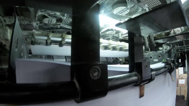 Printed sheets coming out of commercial offset sheetfed printing press