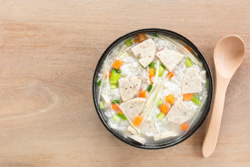 top view of boiled rice with vietnamese pork sausage in a ceramic bowl on wooden table. asian homemade style food concept.