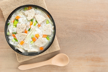 top view of boiled rice with vietnamese pork sausage in a ceramic bowl on wooden table. asian homemade style food concept.