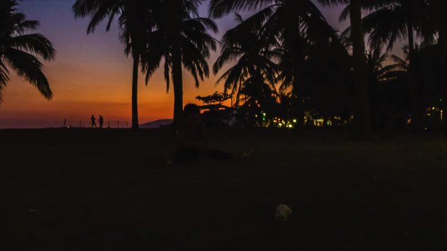 Time lapse of a Child Playing In The Sand with Coconut Trees in the Background, Philippines