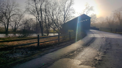 Covered bridge in the morning fog