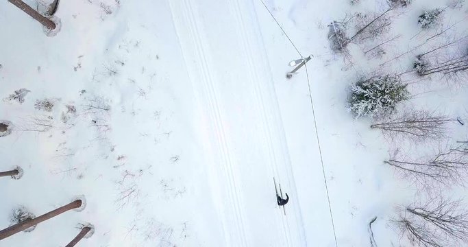 Aerial top down view, cross country skiing in winter forest