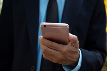 Businessman Holding Mobile Smart Phone and using Smart phone for Business connection