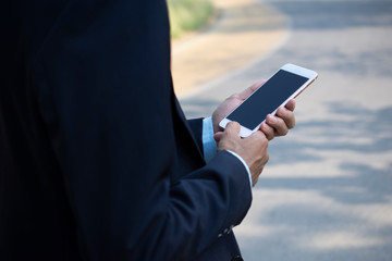 Businessman Holding Mobile Smart Phone and using Smart phone for Business connection