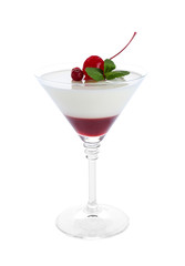 Glass of delicious panna cotta on white background