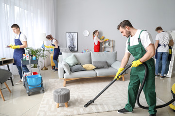 Team of janitors cleaning room