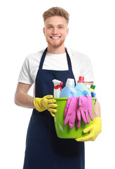 Portrait of male janitor with cleaning supplies on white background