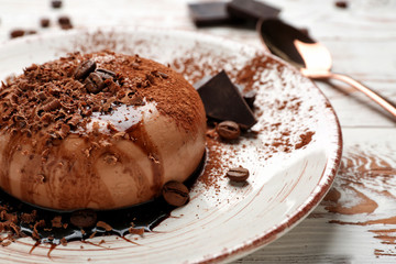 Plate with tasty panna cotta on white table