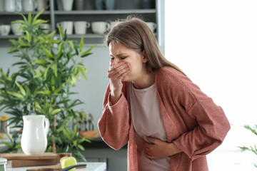 Pregnant woman suffering from toxicosis at home
