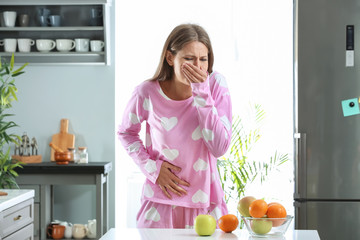 Pregnant woman suffering from toxicosis at home