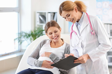 Young pregnant woman visiting her gynecologist in clinic