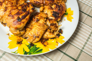 Good fried chicken breast fillet in a plate on the kitchen table.