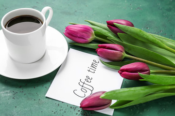 Composition with beautiful tulips and cup of coffee on color background