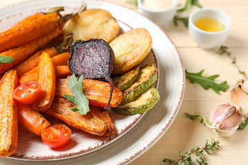 Plate with cooked vegetables on table