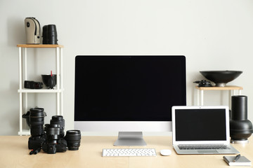 Workplace of professional photographer with modern equipment and computers in studio