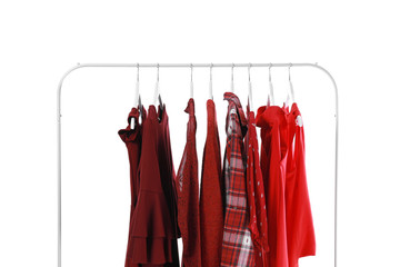 Rack with stylish clothes on white background