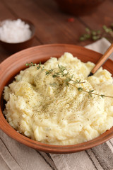 Plate with tasty mashed potato on table