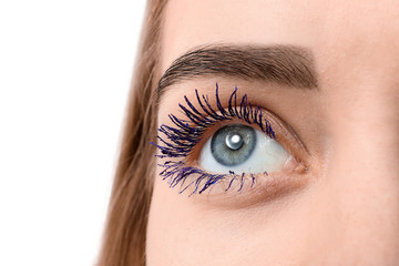 Beautiful young woman with applied color mascara, closeup