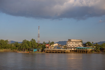 Fototapeta premium The background of a wooden house in the country (Myanmar village) where tourists can take pictures in public while traveling, surrounded by mountains,mangroves,trees,fresh air. 