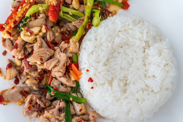 Close up stir fried minced chicken and basil with Jasmine rice on table. Is a popular food in Thailand