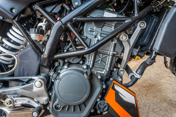 Fototapeta premium Closeup modern motorcycle engine detail system black and brown color.