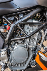 Closeup modern motorcycle engine detail system black and brown color.