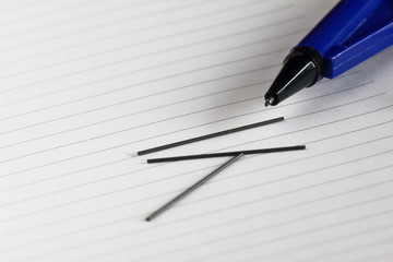 pencil and close up blank pages with lines of open notebook diary