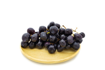 Fresh grapes on wooden plate isolated on white background