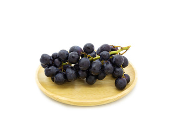 Fresh grapes on wooden plate isolated on white background