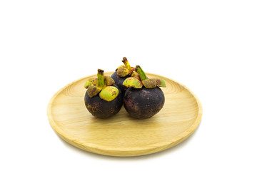 Fresh mangosteen on wooden plate isolated on white background