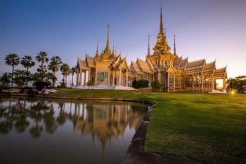 Naklejka premium Wallpaper Wat Lan Boon Mahawihan Somdet Phra Buddhacharn(Wat Non Kum)is the beauty of the church that reflects the surface of the water, popular tourists come to make merit and take a public photo 