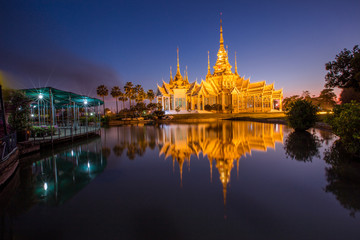 Fototapeta premium Wallpaper Wat Lan Boon Mahawihan Somdet Phra Buddhacharn(Wat Non Kum)is the beauty of the church that reflects the surface of the water, popular tourists come to make merit and take a public photo 