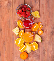 The Fresh strawberry and orange cocktailes with fruits on a wooden rustic background. Freshly...