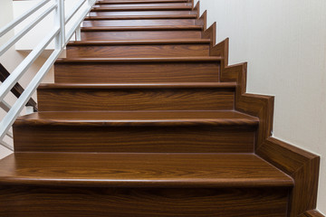 Staircase custom built home interior with wood staircase and white walls.