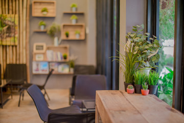 Blurred background of interior room (bakery coffee restaurant) by bringing a vase, wooden table Bookshelves, for the beauty of the shop and impressing those found 