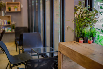 Blurred background of interior room (bakery coffee restaurant) by bringing a vase, wooden table Bookshelves, for the beauty of the shop and impressing those found 