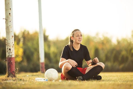 Young female soccer player resting after her training - Powered by Adobe