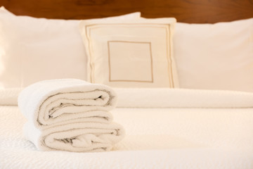 White towel on bed in hotel room