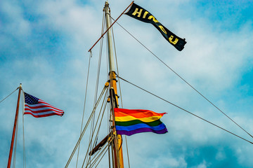 Three flags on yachts masts in Provincetown' marina, Massachusetts