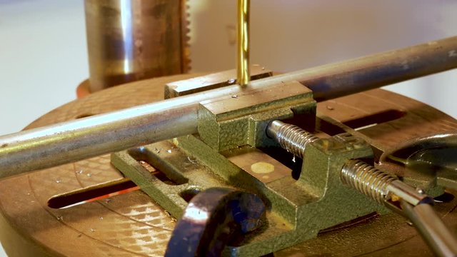 Drilling or enlarging a hole in a pipe - close up