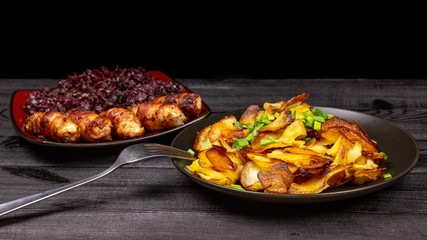 Fried homemade grilled sausages or chevapchichi with stewed sauerkraut on a wooden rustic background