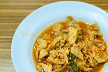 Stir fried hot and spicy sauce with pork, crispy basil leaf on top, served together with aromatic jasmine rice, an authentic popular traditional Thai food.