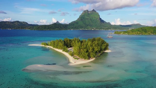 Bora Bora in French Polynesia. Aerial view of Motu Tapu paradise island and turquoise blue water in coral reef lagoon and Mt Pahia, Mount Otemanu, Tahiti, South Pacific Ocean.