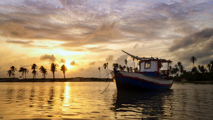 Fototapeta premium old fishing boat at sunset