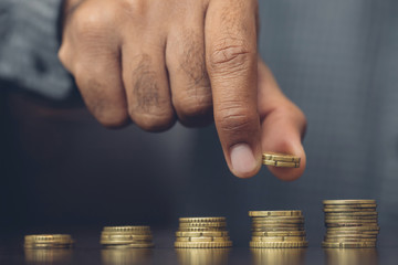 Saving money. businessman hand putting stack coins to show concept of growing savings money finance...