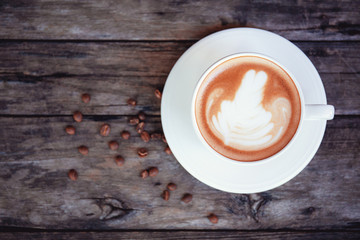 Coffee cup on wood with top view.