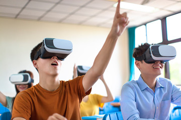 students having fun with new technology vr headset in classroom