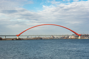 Fototapeta na wymiar Red road bridge across the river